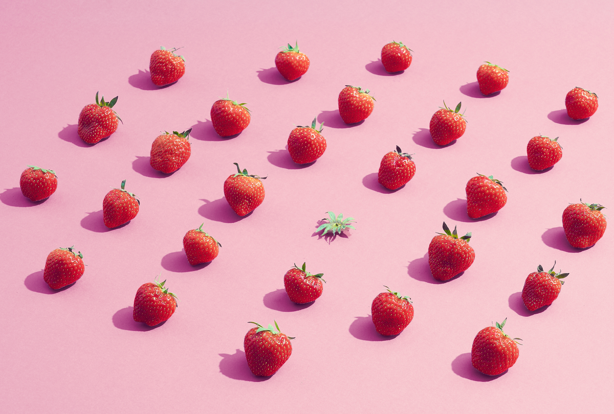 A group of strawberries surrounding an eaten one (Getty Images / Daniel Grizelj)
